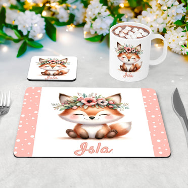 White placemat, mug and coaster set with cute woodland fox wearing a flower crown. Personalised with your childs name in pale pink