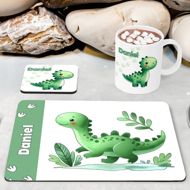 White Placemat, Mug and Coaster Set with cute playful green dinosaur design with plants and dinosaur prints. Personalised with Childs name