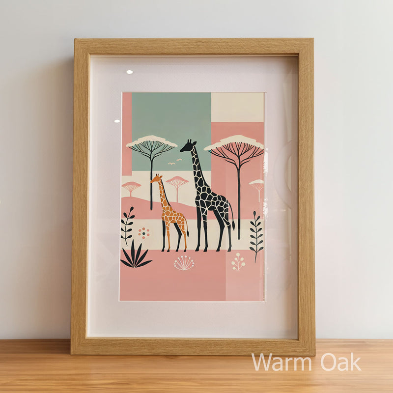 Framed artwork with two giraffes and trees on a pink and blue background, displayed on a wooden floor.