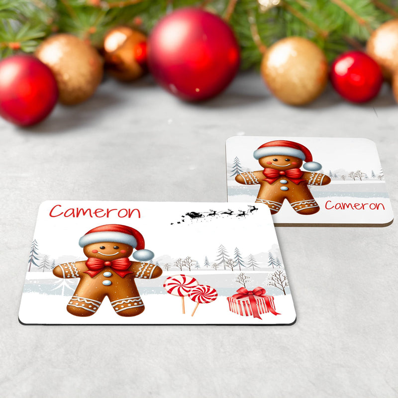 Kids Christmas Table Wear Set. A white mug featuring bright, bold gingerbread man design. Coaster and placemat have similar design on a white background. All personalised with childs name