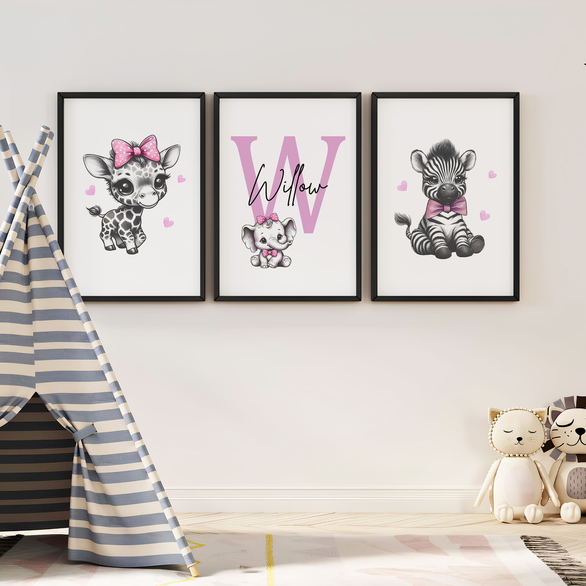 Set of three A4 prints in the style of pencil drawings. Each print features a cartoon baby giraffe, baby elephant, and baby zebra in black and white. They all wear a pink bow, with a few small pink hearts in the background. The middle image contains the elephant, which is smaller than the other two images. In the background, there is a large initial with a personalised name in black.