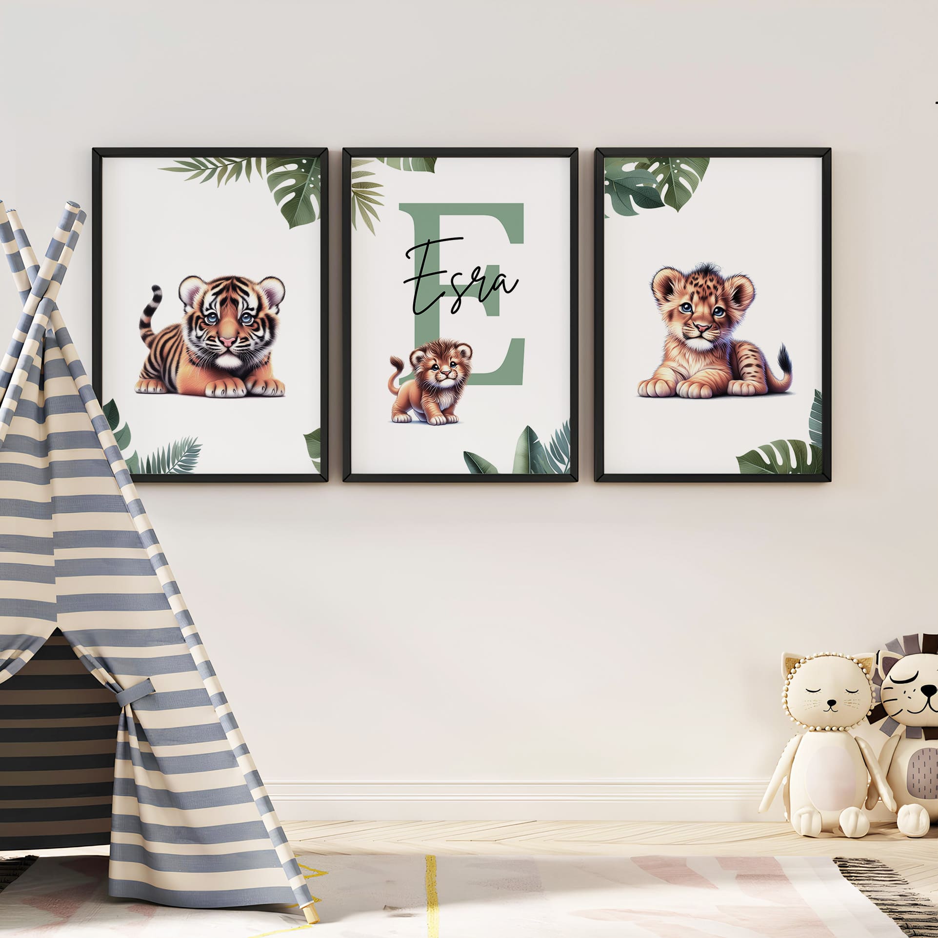 Set of three A4 prints featuring baby big cats - lion cub, tiger cub, and cheetah cub. The animals are depicted in a cartoony, bright style, resembling coloured pencil drawings. Jungle-style leaves adorn the edges of the prints. The middle print features a smaller animal compared to the others, with a large initial letter in the background. A personalised name in black overlays the initial letter.