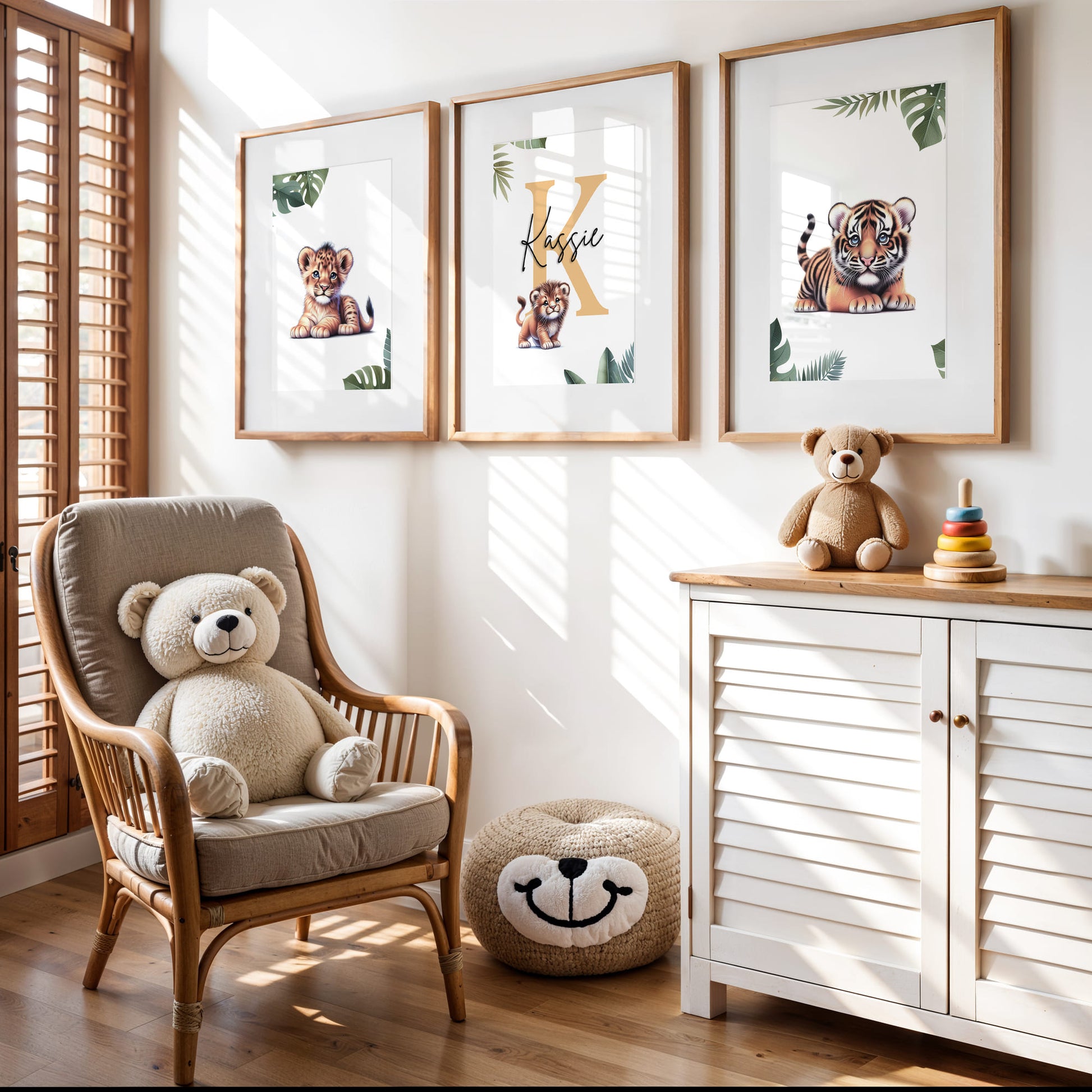 Set of three A4 prints featuring baby big cats - lion cub, tiger cub, and cheetah cub. The animals are depicted in a cartoony, bright style, resembling coloured pencil drawings. Jungle-style leaves adorn the edges of the prints. The middle print features a smaller animal compared to the others, with a large initial letter in the background. A personalised name in black overlays the initial letter.