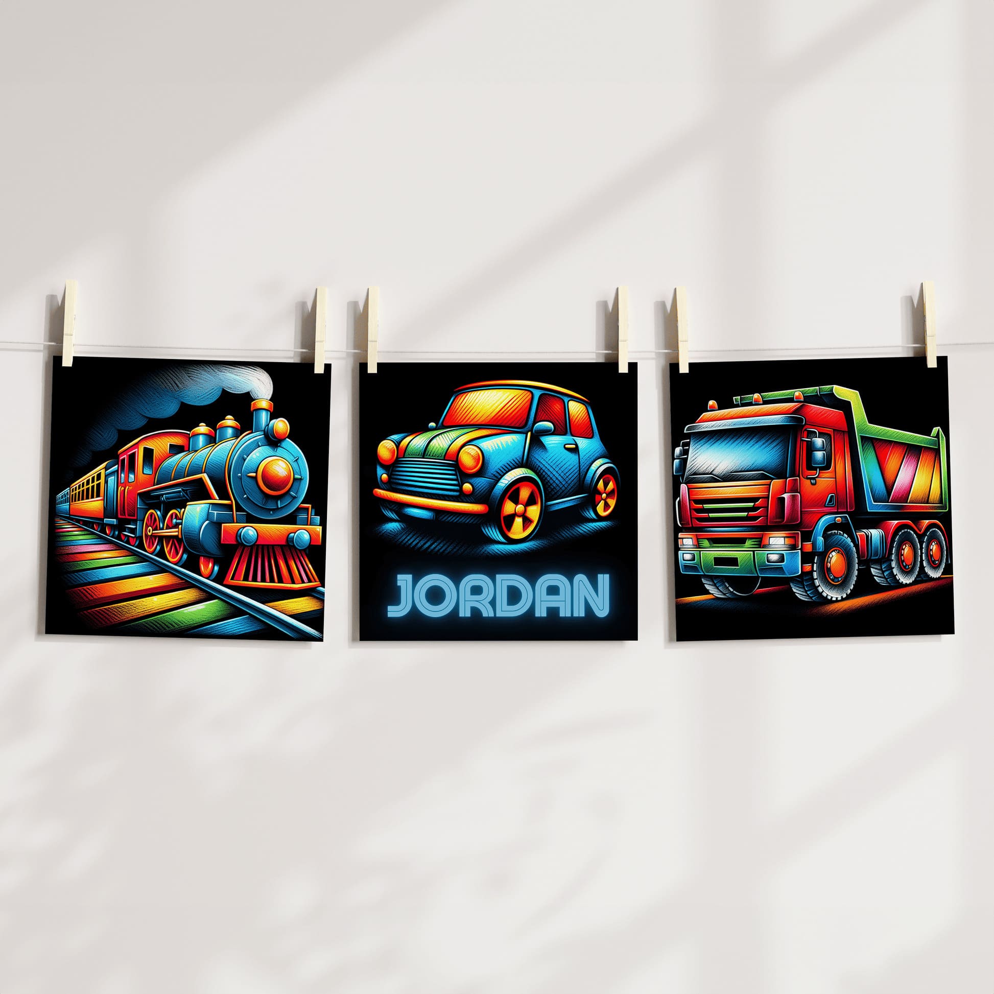 Three square nursery prints. Images show colourful, multicoloured truck, train and car against a black background, One print is personalised with childs name in a neon style font