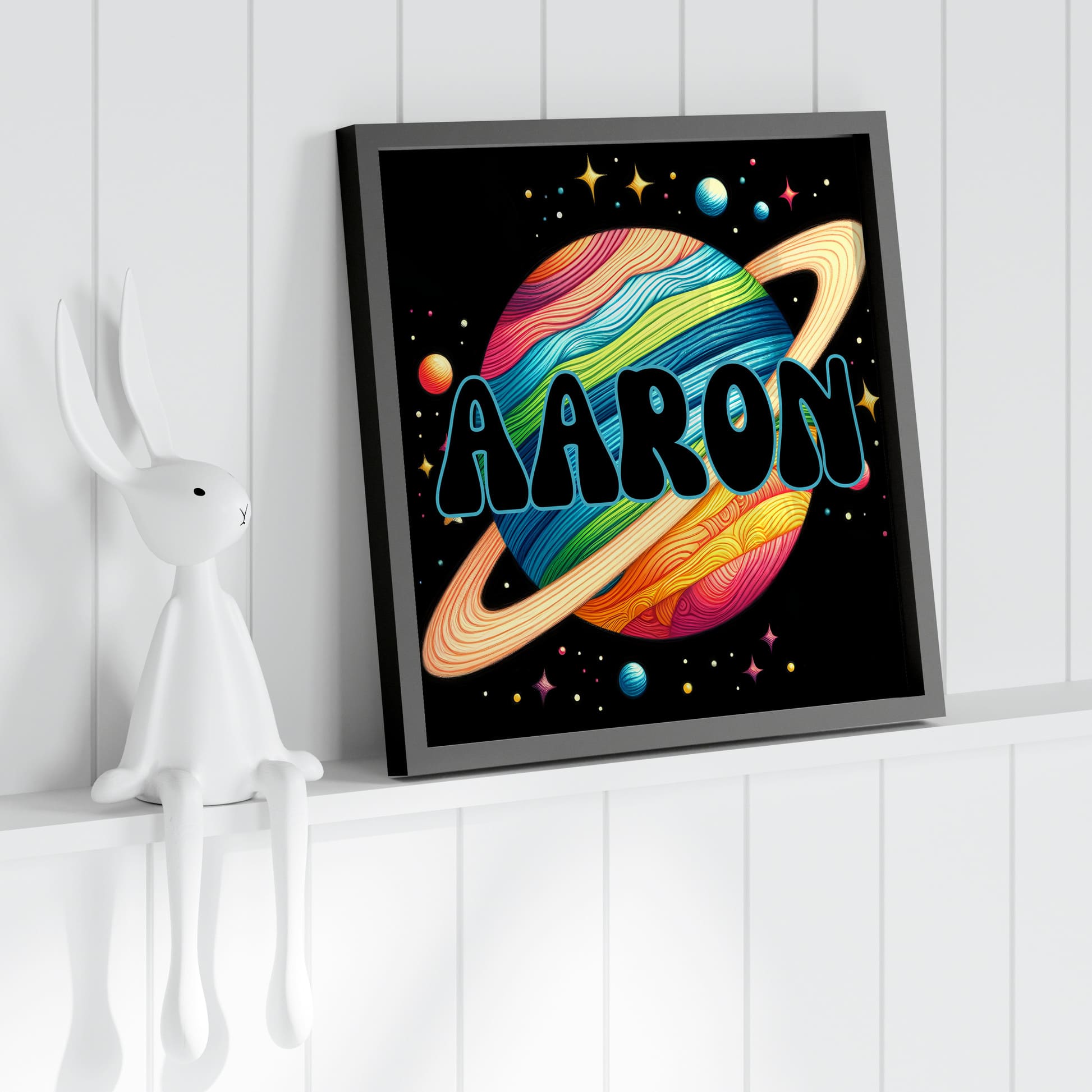 Set of Three Square Nursery Prints. Black background with bright colourful images with a space theme - astronaut, rocket, planet. One print is personalised with a name