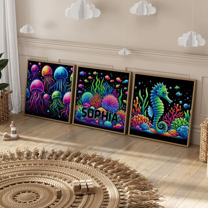 Set of 3 square nursery prints. A neon underwater design featuring seahorse, coral and jellyfish, on a black background. One print personalised with childs name