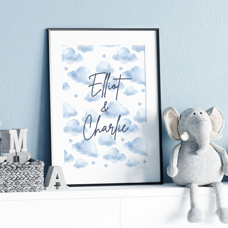 Two A4 Prints. One showing 2 cartoon elephants dressed in blue dungarees, one with a bow, one without and reads "BFF Born Forever Friends". The other print has blue watercolour style clouds, with children's name in black writing across it