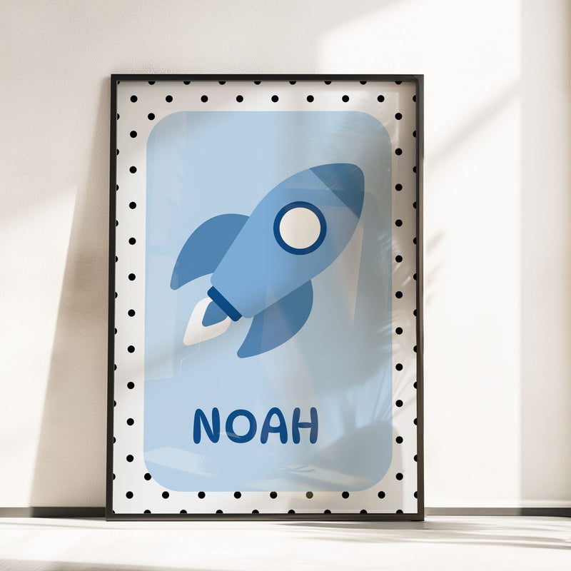 3 Nursery Prints in Blue. One features spotty background with childs initial, one with simple stars on blue background, one with a rocket and childs name