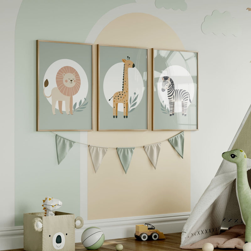 Set of three A4 prints featuring minimalist illustrations in muted tones. Each print depicts a different animal: a lion, a zebra, and a giraffe. The background is sage green with a white circle on which the animal is overlaid.