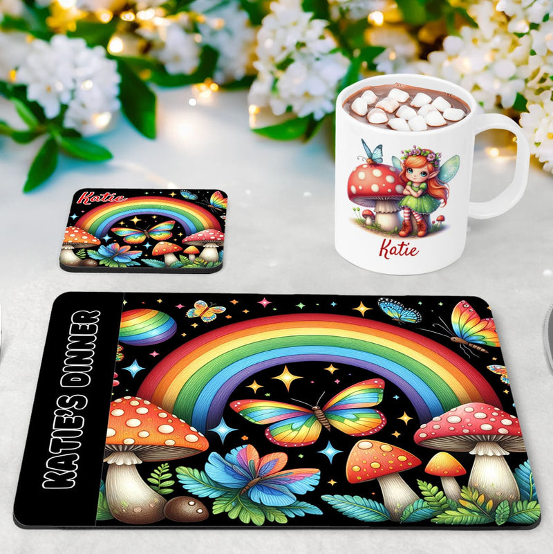 Fairy Garden placemat, mug and coaster set. Multicoloured rainbows, butterflies and toadstools pop on the black coaster & placemat, while the while mug features a winged fairy. All items personalised with name of your choice