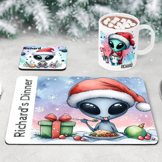 Christmas dinnerware set for kids, personalised with child’s name. Includes custom alien-themed placemat, coaster, and mug. Unique holiday gift idea for children; vibrant colours & fun alien design make it ideal for festive table decor and Christmas