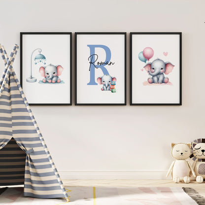 Set of three A4 prints in watercolour style. Each print depicts a cartoon baby elephant. In the first print, the elephant sit by a mobile; in the second, it holds a balloon. The middle elephant has counting clocks nearby and is smaller than the other two, with a large initial in the background. A personalised name in black overlays the initial.