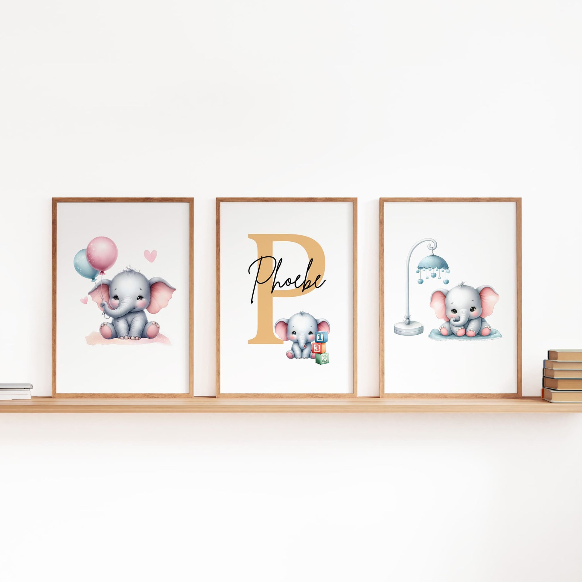 Set of three A4 prints in watercolour style. Each print depicts a cartoon baby elephant. In the first print, the elephant sit by a mobile; in the second, it holds a balloon. The middle elephant has counting clocks nearby and is smaller than the other two, with a large initial in the background. A personalised name in black overlays the initial.