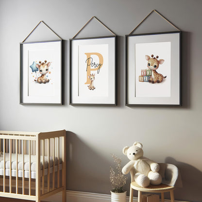 Set of three A4 prints in watercolour style. Each print depicts a cartoon baby giraffe In the first print, the giraffe sits by counting blocks; in the second, it holds a balloon. The middle giraffe is smaller than the other two, with a large initial in the background. A personalised name in black overlays the initial.