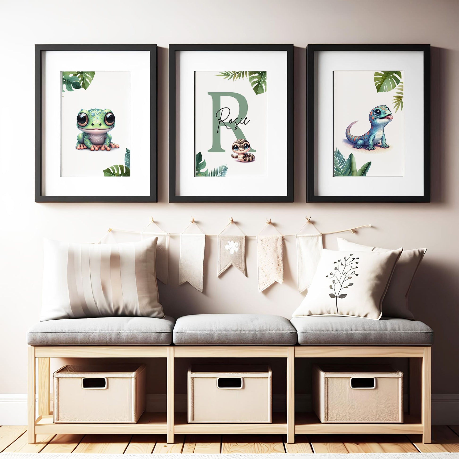 Set of three A4 prints featuring reptiles/amphibians - tree frog, lizard, and snake. The animals are depicted in a cartoony, bright style resembling coloured pencil drawings. Jungle-style leaves decorate the edges of the prints. The middle print features a smaller animal than the others, with a large initial letter in the background. A personalised name in black overlays the initial letter.
