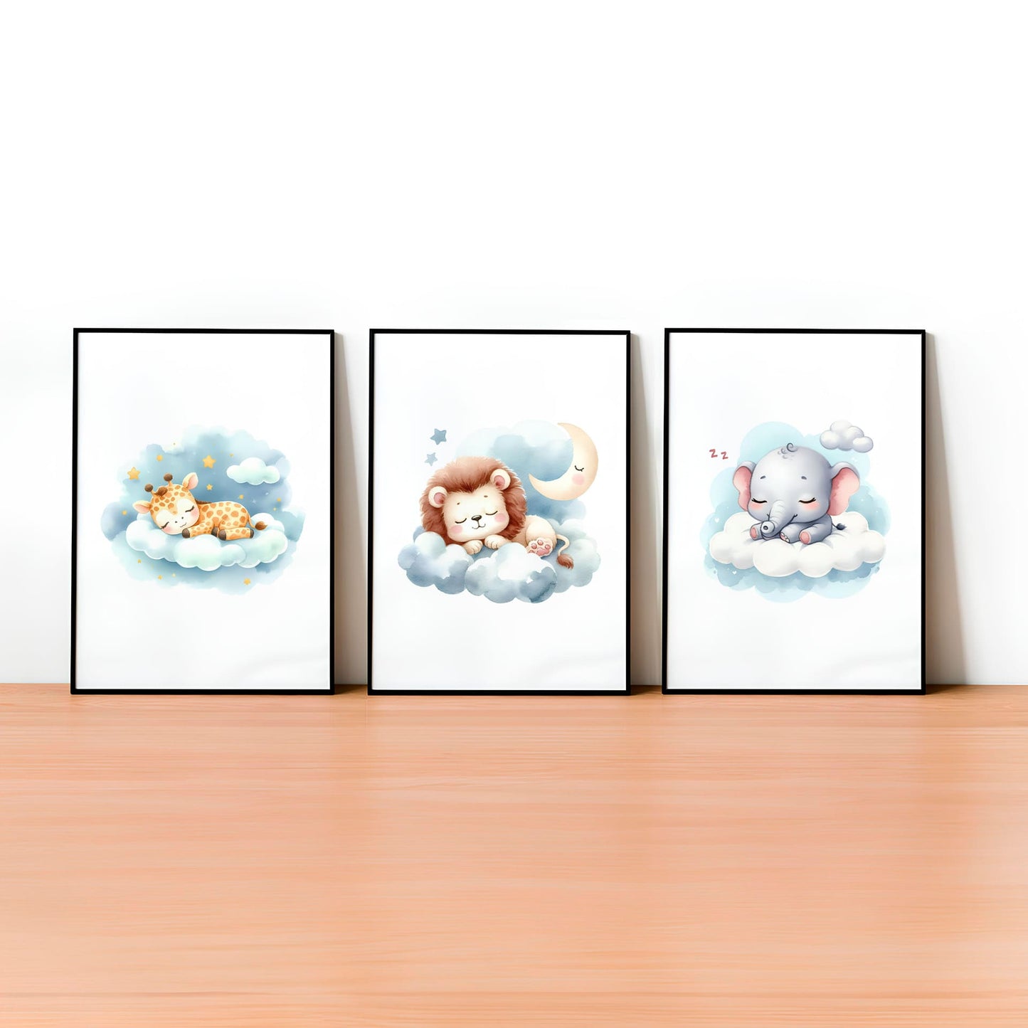 Set of three A4 prints in watercolour style. The first print shows a baby tiger sleeping on a cloud, the second depicts a baby elephant sleeping on a cloud, and the third features a baby giraffe sleeping on a cloud.
