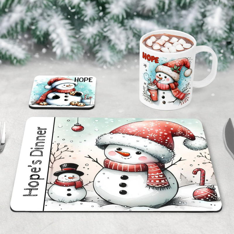 Childrens Christmas Dinner Set - a mug, coaster and placemat set featuring cute snowmans designs, primarily in black, white, red and blue. Personalised with Childs name