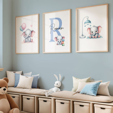 Set of three A4 prints in watercolour style. Each print depicts a cartoon baby elephant. In the first print, the elephant sit by a mobile; in the second, it holds a balloon. The middle elephant has counting clocks nearby and is smaller than the other two, with a large initial in the background. A personalised name in black overlays the initial.