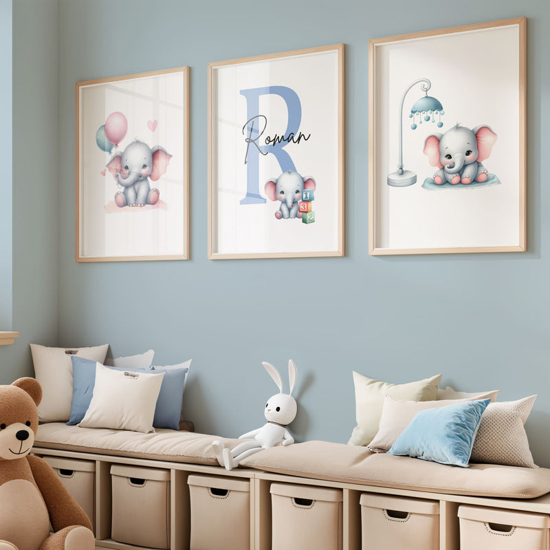 Set of three A4 prints in watercolour style. Each print depicts a cartoon baby elephant. In the first print, the elephant sit by a mobile; in the second, it holds a balloon. The middle elephant has counting clocks nearby and is smaller than the other two, with a large initial in the background. A personalised name in black overlays the initial.