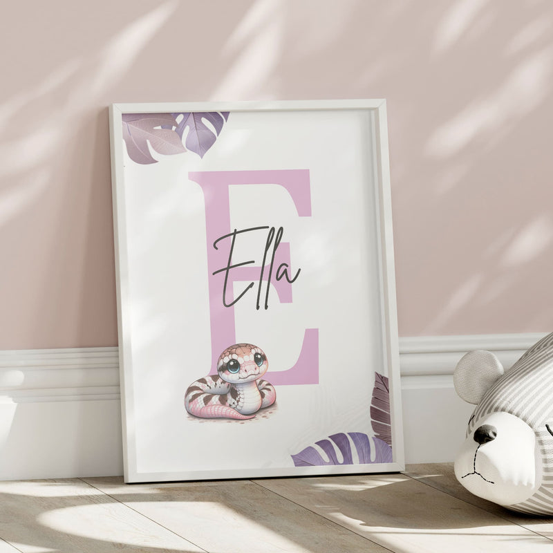 Set of three A4 prints featuring pink/purple reptiles/amphibians - frog, lizard, and snake. The animals are depicted in a cartoony, style resembling coloured pencil drawings in warm shades of pink, purple and orange. Jungle-style leaves in shades of purple decorate the edges of the prints. The middle print features a smaller animal than the others, with a large initial letter in the background. A personalised name in black overlays the initial letter.