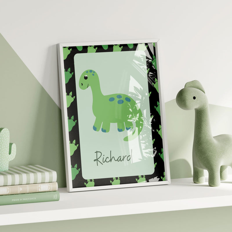 3 Simple, bright dinosaur nursery prints in greens and black. One with a dinosaur illustration and reads "roar and explore", one with a dinosaur pattern on a black background and childs initial in bold green, third print with a dinosaur and childs name