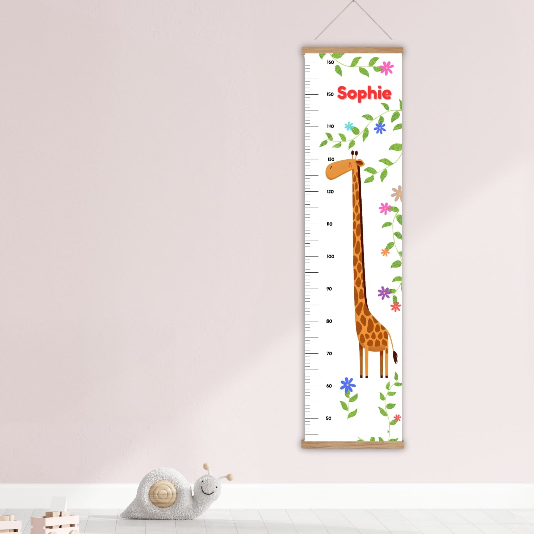 Childs height chart featuring a tall giraffe and bright flowers. Personalised with your childs name. Available with a choice of black, white and natural hangers