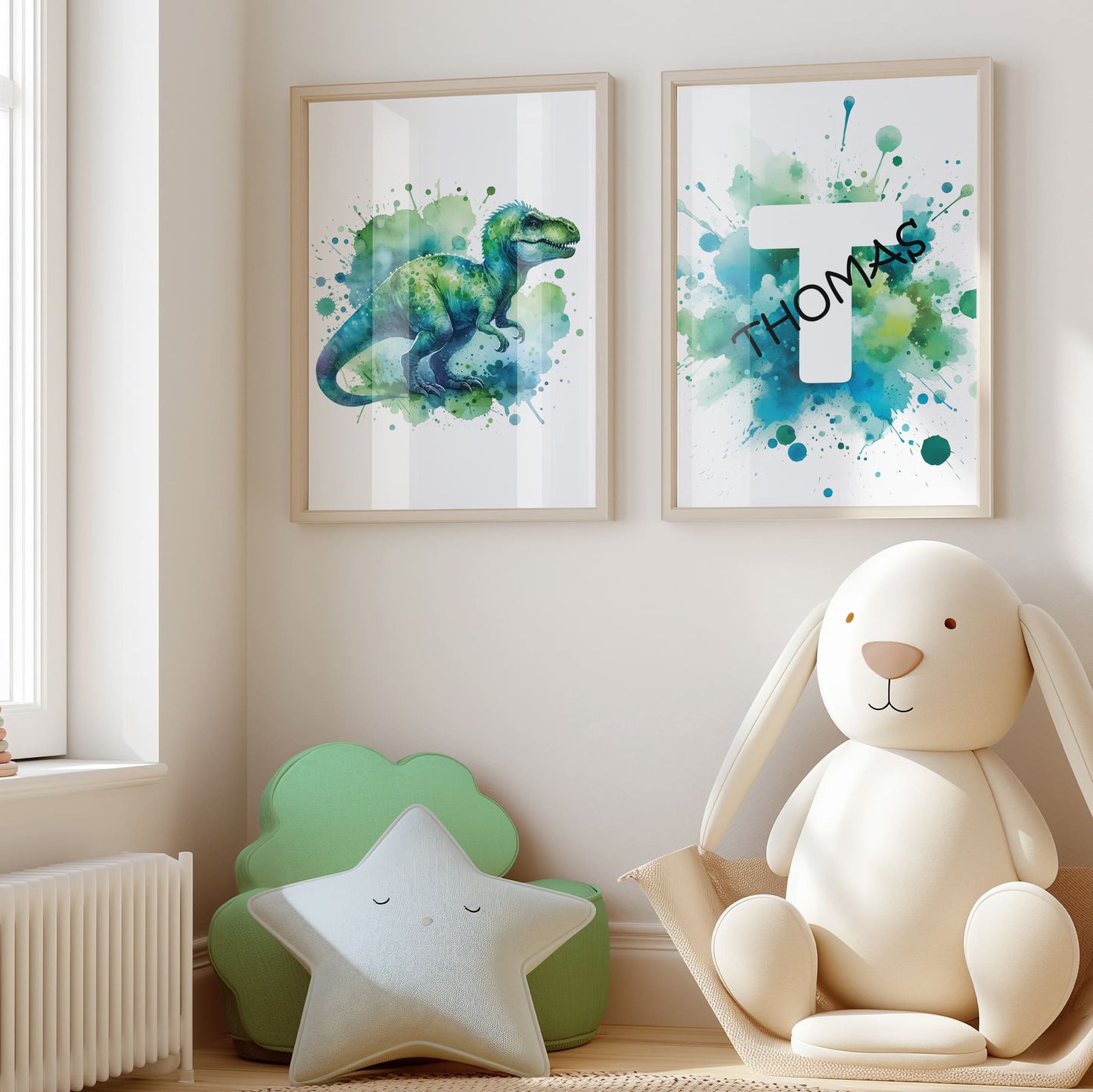 Set of 2 green/blue prints for children's nursery décor. One print feature vibrant, green/blue dinosaur in watercolour effects, while the second showcases watercolour splashes with a white initial letter and personalised black name