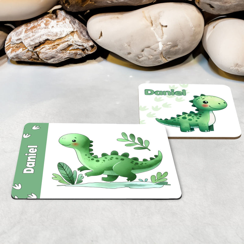 White Placemat and Coaster Set with cute playful green dinosaur design with plants and dinosaur prints. Personalised with Childs name