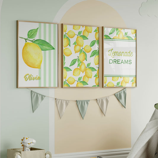 Personalised lemon nursery wall art set with three watercolour prints – one with a yellow lemon and custom child’s name, one with a repeating lemon pattern, and one featuring the quote "Lemonade Dreams". Fresh and vibrant nursery decor perfect for a baby girl or boy’s room.