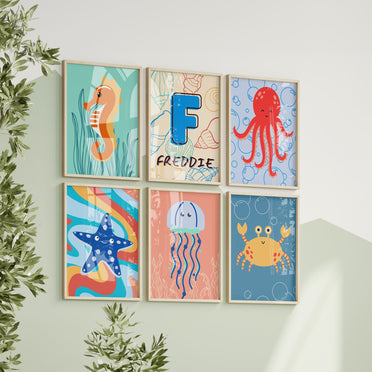 Set of Six A5 Prints. All in beachy colours - blue, sandy, turquoise. Images of Octopus, jellyfish, starfish, crab, seahorse. Simple design suited for young children. One print is personalised with Childs name and initial