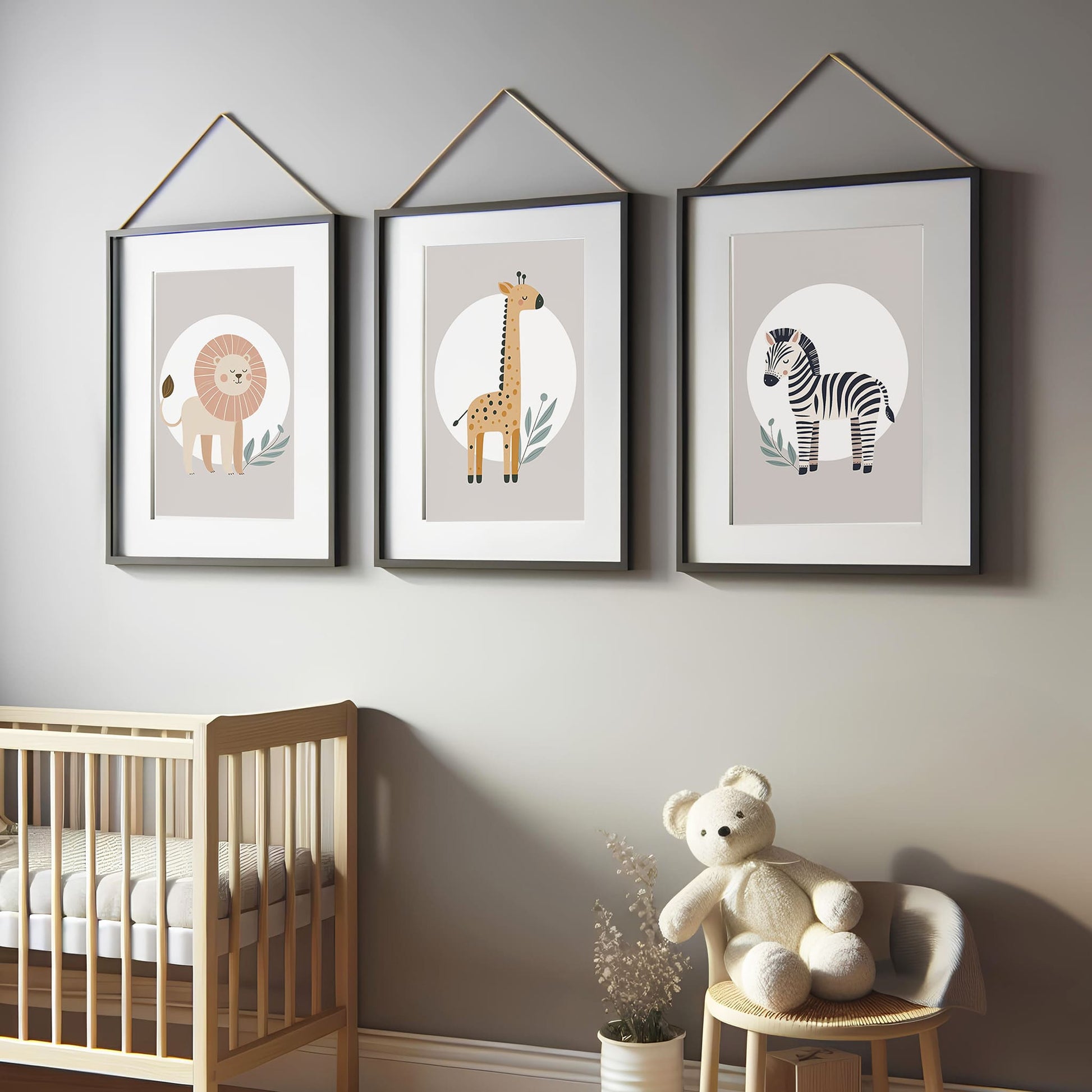 Set of three A4 prints featuring minimalist illustrations in muted tones. Each print depicts a different animal: a lion, a zebra, and a giraffe. The background is tan coloured with a white circle on which the animal is overlaid.