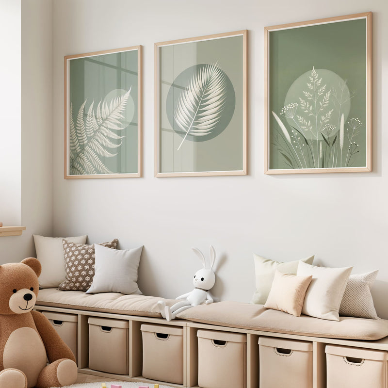Three botanical nursery prints with white fern and leaf illustrations on soft green tones, featuring a stylish abstract circle for a unique, modern touch.