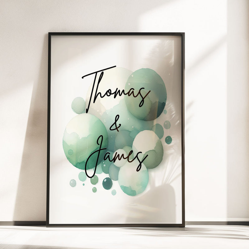 Set of 2 personalised prints for twins' nursery décor. One print features two cute monkeys playing, while the other showcases vibrant watercolour splashes overlaid with children's names in bold black lettering