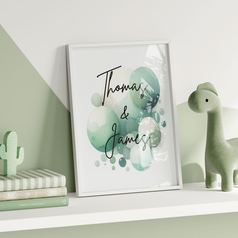 Set of 2 personalised prints for twins' nursery décor. One print features two cute monkeys playing, while the other showcases vibrant watercolour splashes overlaid with children's names in bold black lettering