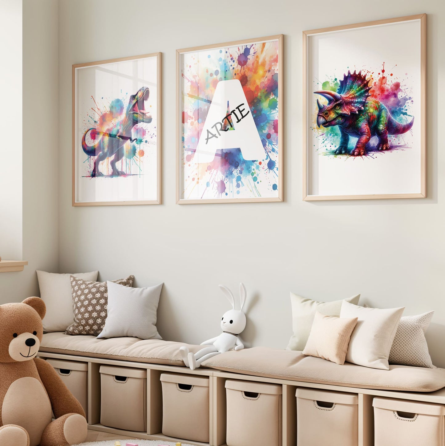 Set of 3 dinosaur prints for children's nursery décor. Two prints feature vibrant, multicoloured dinosaurs in watercolour effects, while the third showcases watercolour splashes with a white initial letter and personalised black name
