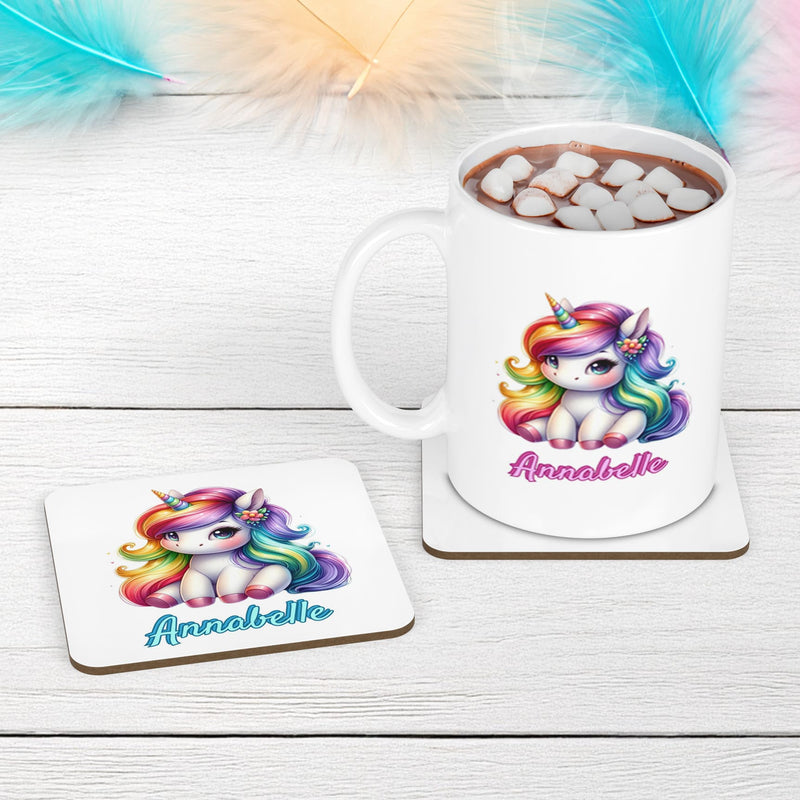 White mug and coaster set with cute simple unicorn design with multicoloured mane. Personalised with your childs name in turquoise and pink