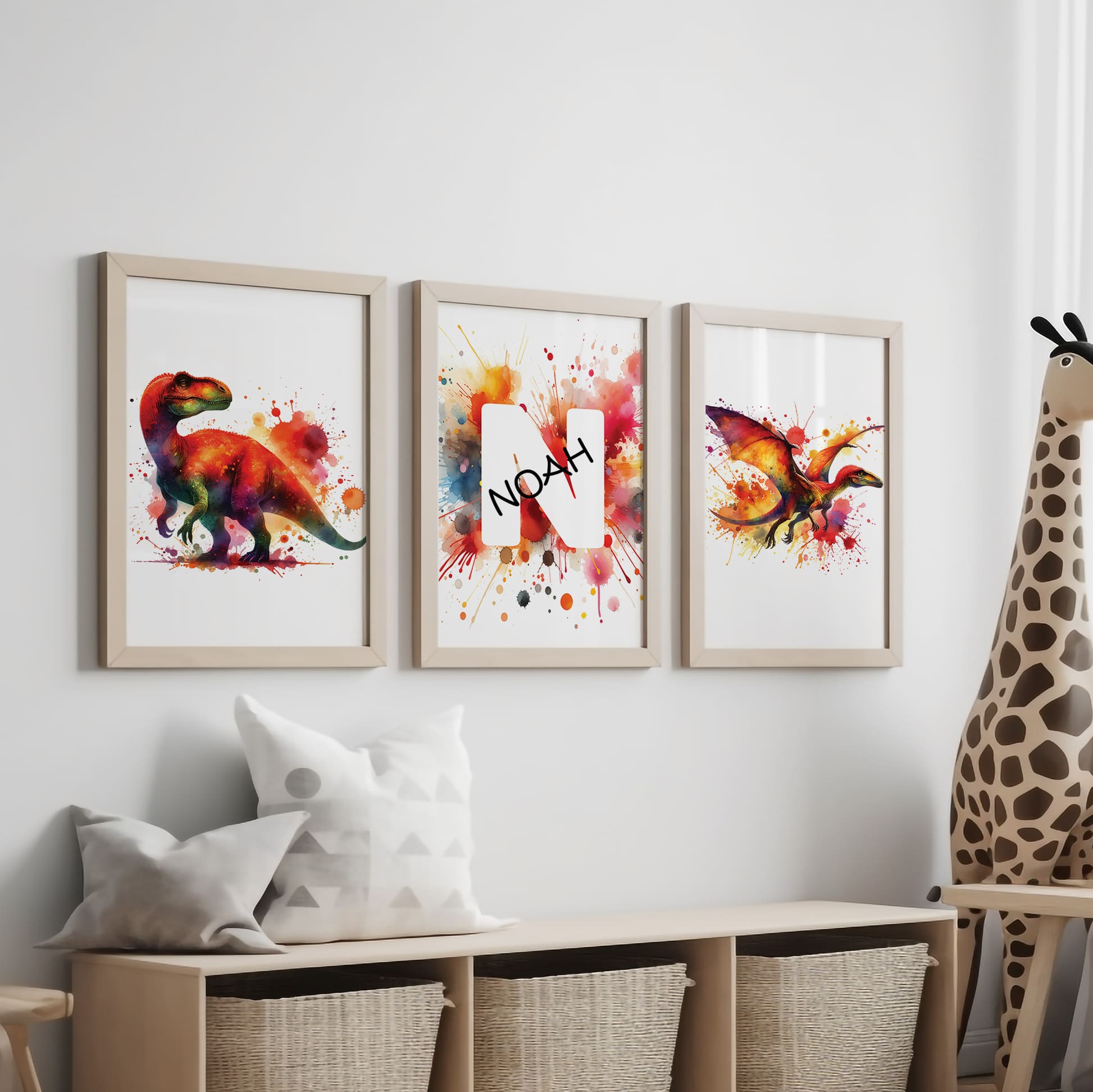 Set of 3 dinosaur prints for children's nursery décor. Two prints feature vibrant, red and yellow dinosaurs in watercolour effects, while the third showcases watercolour splashes with a white initial letter and personalised black name