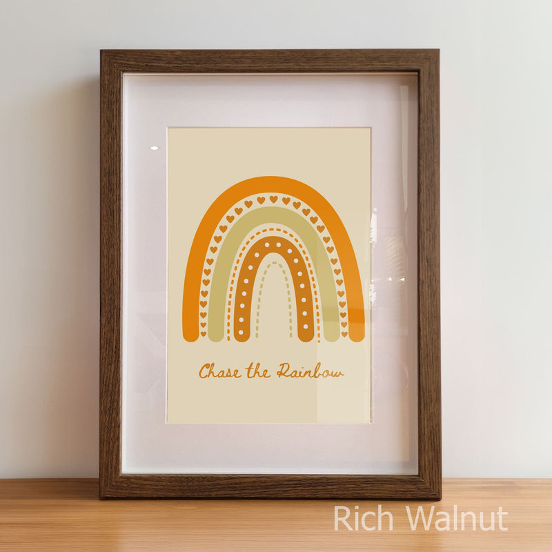 Framed artwork with a rainbow design and text on a plain background