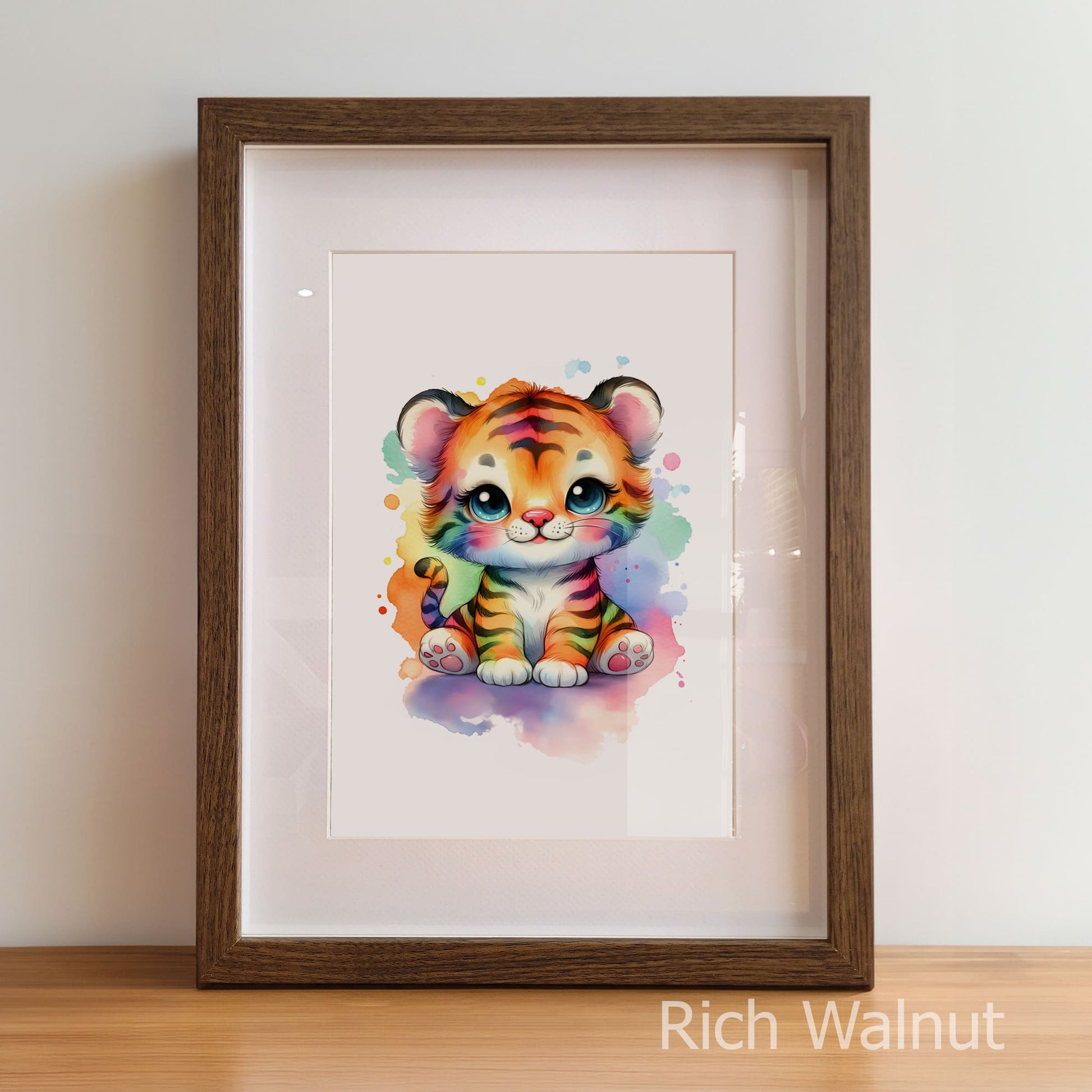 Framed artwork of a colorful tiger cub on a white wall.
