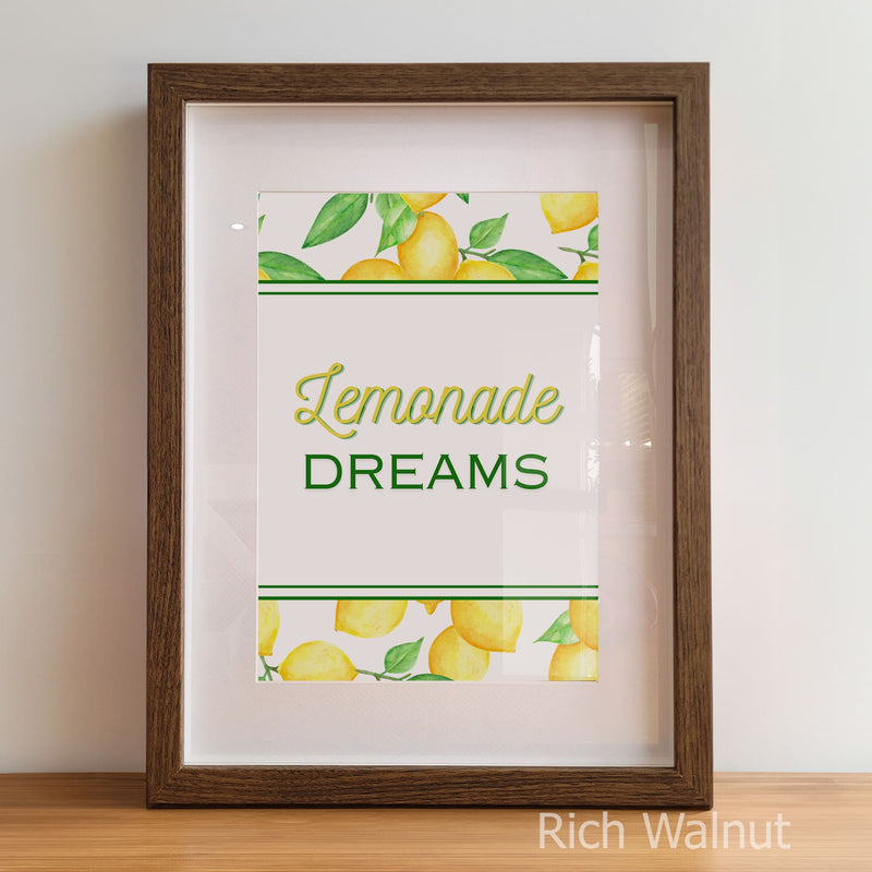 Framed print with 'Lemonade Dreams' text and lemon illustrations on a white background.
