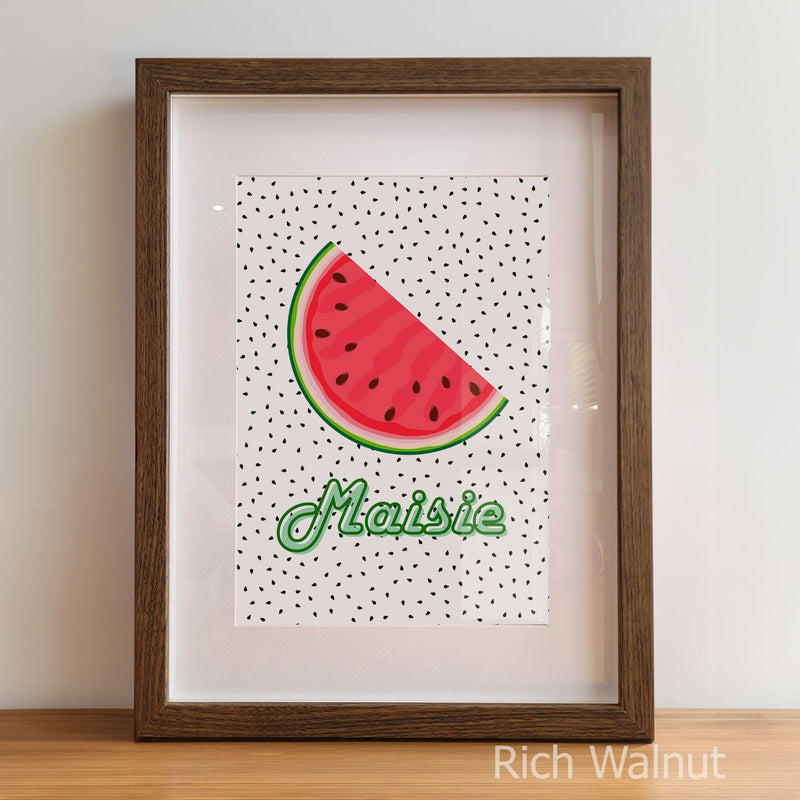 Framed artwork with a watermelon slice and the name 'Maisie' on a polka dot background.