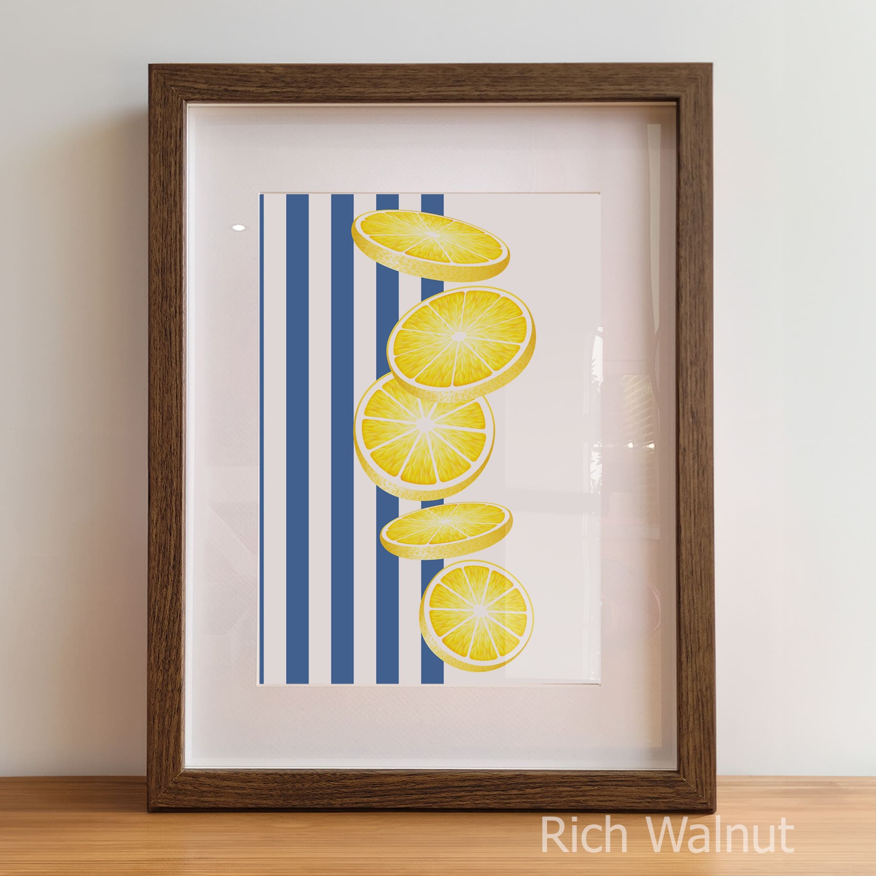 Framed artwork with lemon slices on a blue striped background