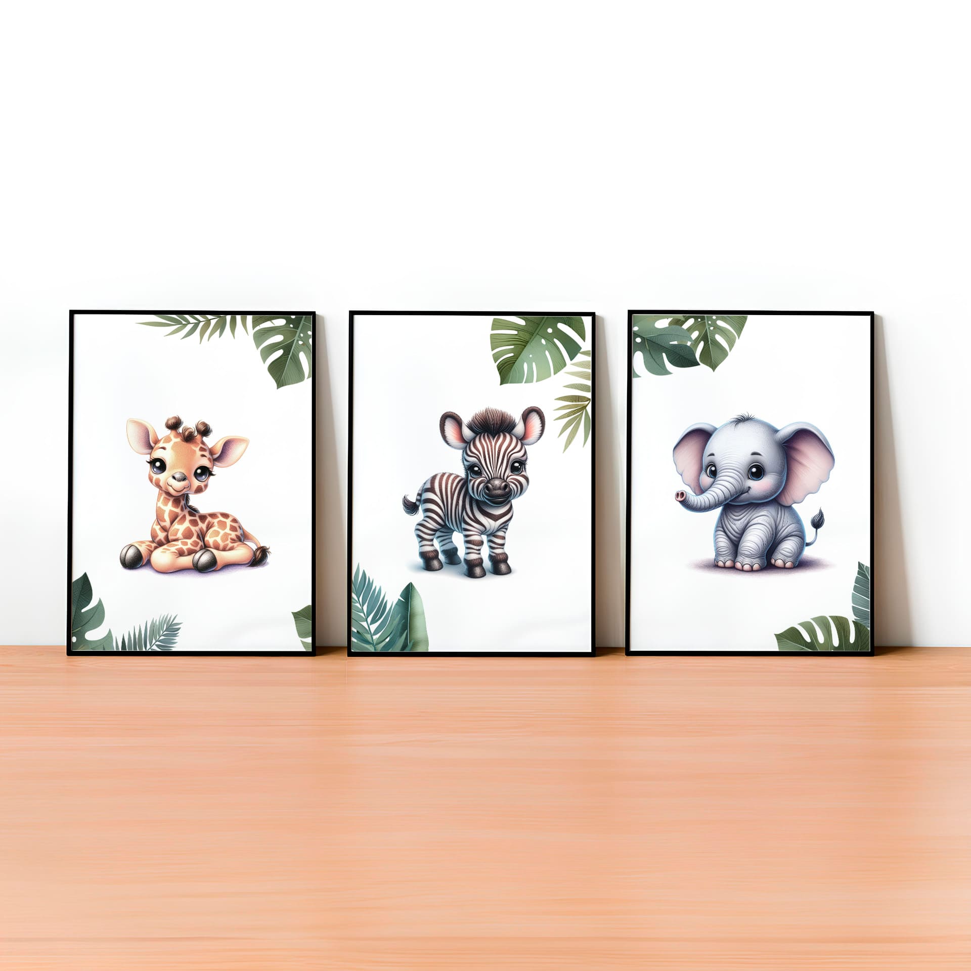 Set of  three A4 prints featuring cartoony and brightly illustrated safari animals – an elephant, giraffe, and zebra. The animals are depicted in the style of coloured pencil drawings with jungle-style leaves adorning the edges of the prints. 