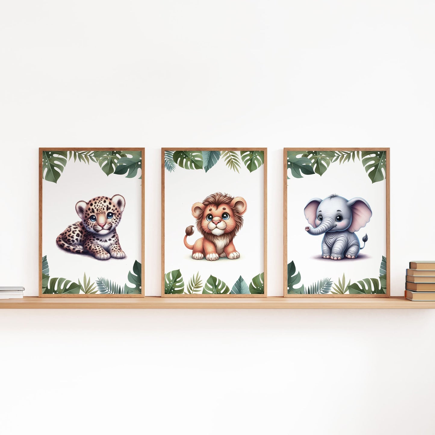 FIrst three of a set of six A4 prints featuring safari animals - lion cub, tiger cub, cheetah cub, elephant, giraffe, and zebra. The animals are depicted as baby animals, in a cartoony and bright style reminiscent of coloured pencil drawings. Jungle-style leaves adorn the edges of the prints.
