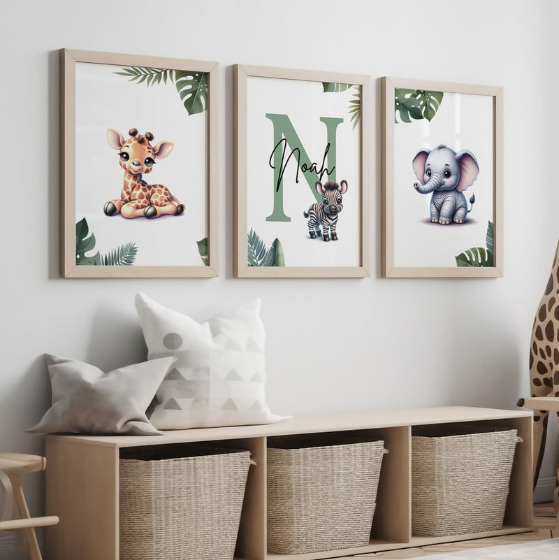 Set of three A4 prints featuring cartoony and brightly illustrated safari animals – an elephant, giraffe, and zebra. The animals are depicted in the style of coloured pencil drawings with jungle-style leaves adorning the edges of the prints. The middle print features a smaller animal compared to the others, with a large initial letter in the background. A personalised name is overlaid in black across the initial letter