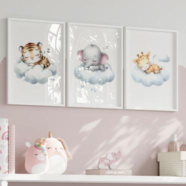 Set of three A4 prints in watercolour style. The first print shows a baby tiger sleeping on a cloud, the second depicts a baby elephant sleeping on a cloud, and the third features a baby giraffe sleeping on a cloud.
