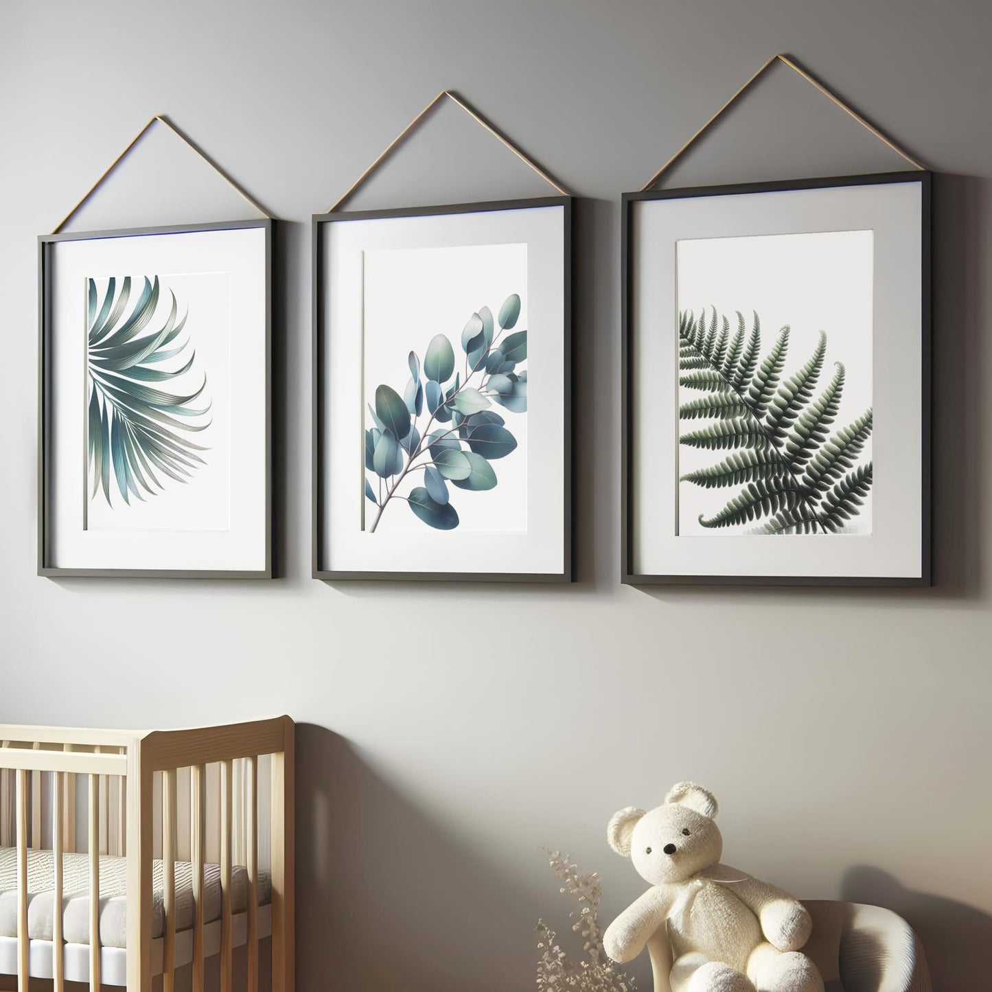 Three botanical prints featuring muted green leaves, including fern, eucalyptus, and palm, on a white background for a soft, elegant nursery aesthetic.
