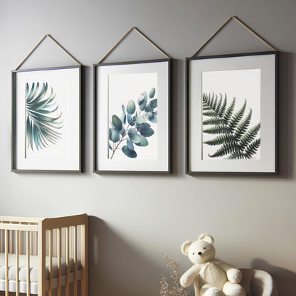 Three botanical prints featuring muted green leaves, including fern, eucalyptus, and palm, on a white background for a soft, elegant nursery aesthetic.