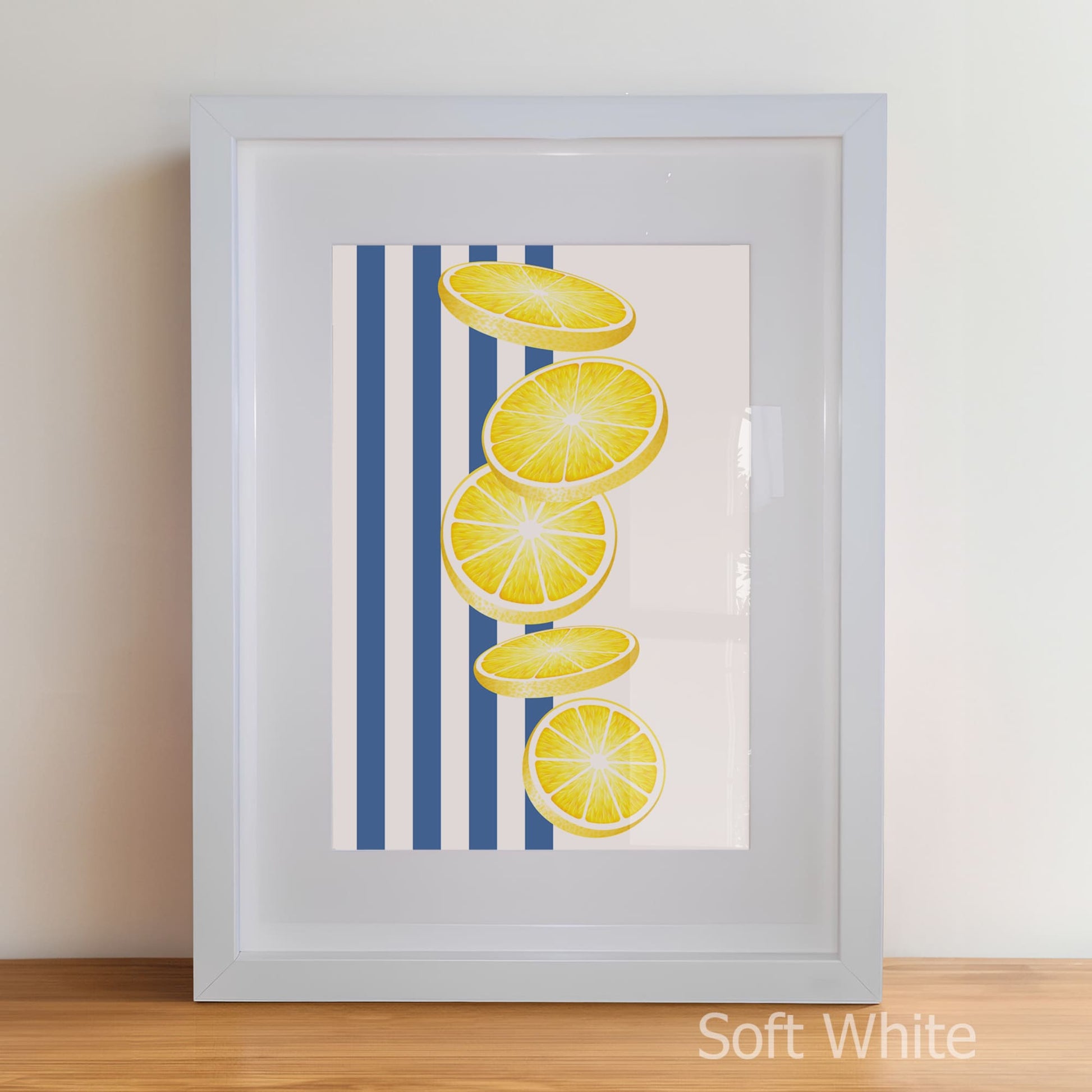Framed artwork with lemon slices on a blue striped background