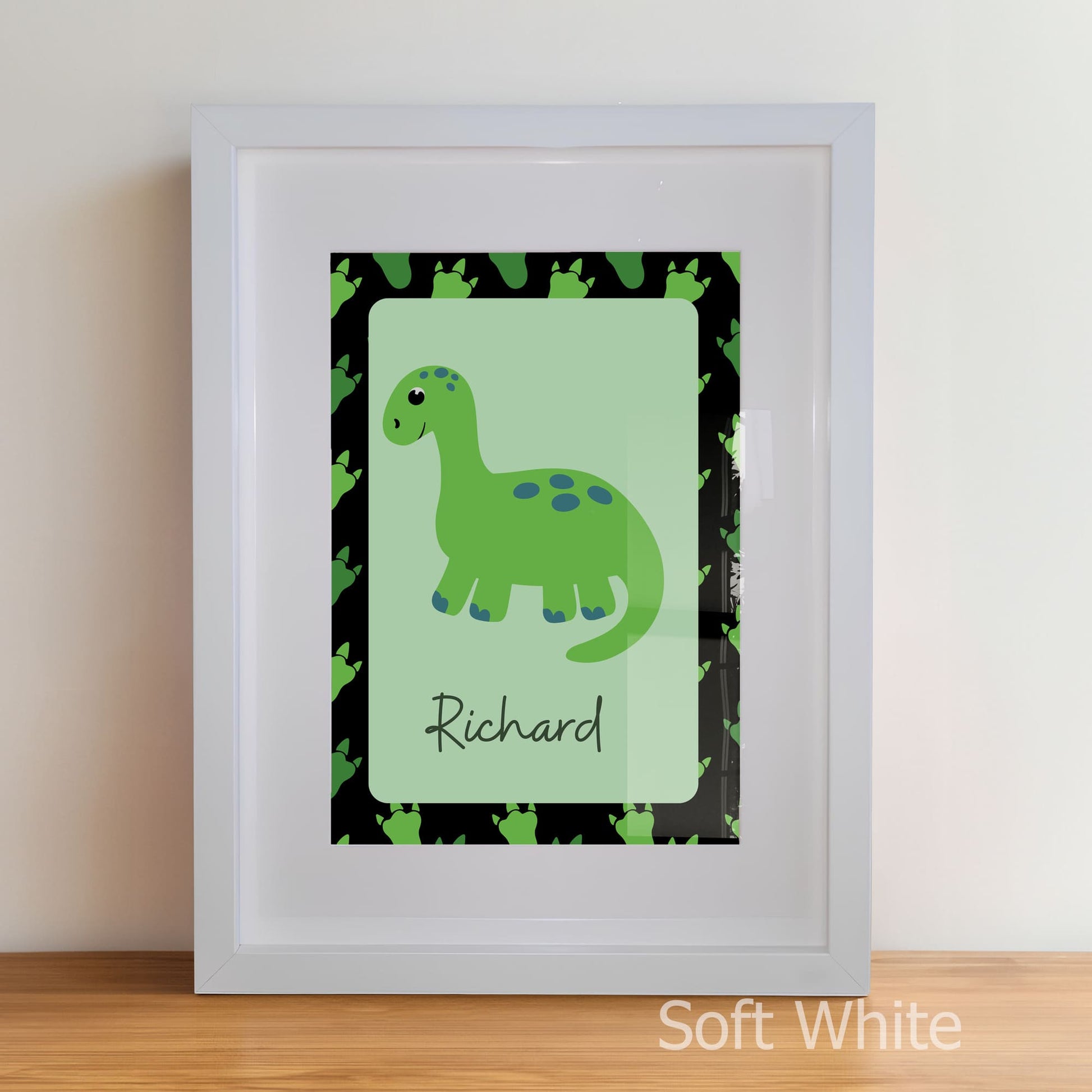 Framed artwork with a green dinosaur illustration and name 'Richard' on a light green background.